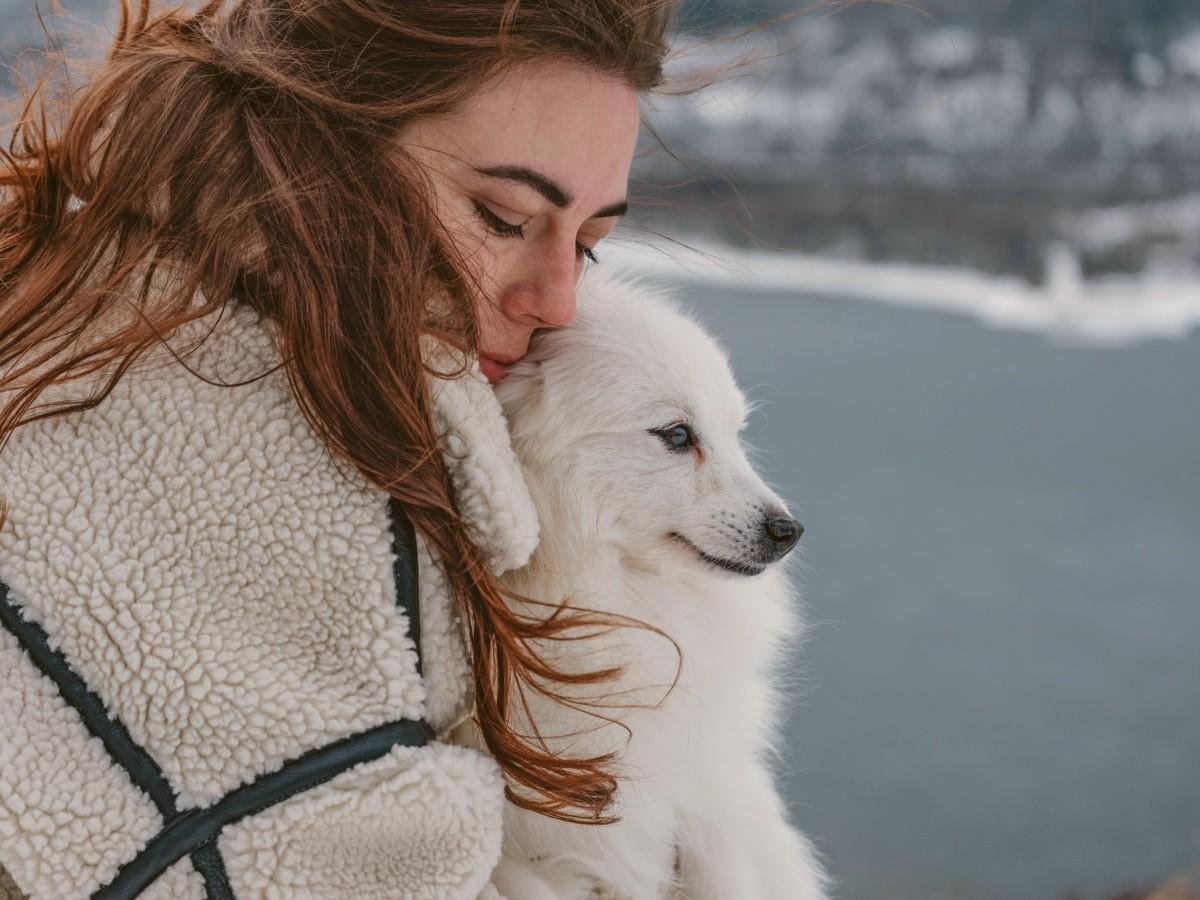 lady with puppy near lake